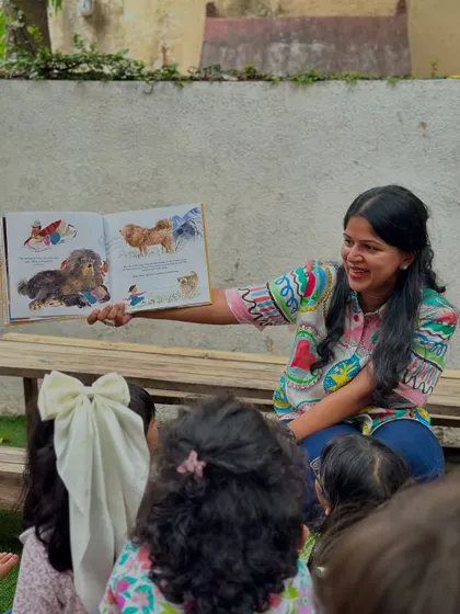 A child's face lights up as the author shows them the illustrations from the book. These moments foster a deep and personal connection to books and the people who create them.