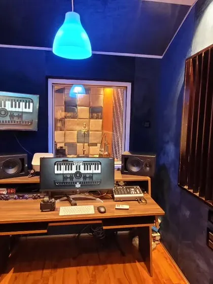 A look inside our control room with the lights dimmed for a creative session. The setup is designed to be both functional and comfortable, so you can focus entirely on the music.
