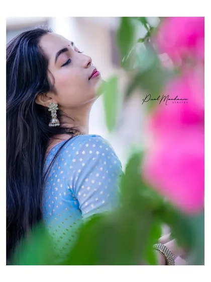 A serene portrait where the subject is lost in the moment. The soft light and natural elements create a peaceful and beautiful image.