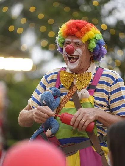 A professional clown entertainer brings laughter and joy to the party, interacting with the children and making balloon animals.