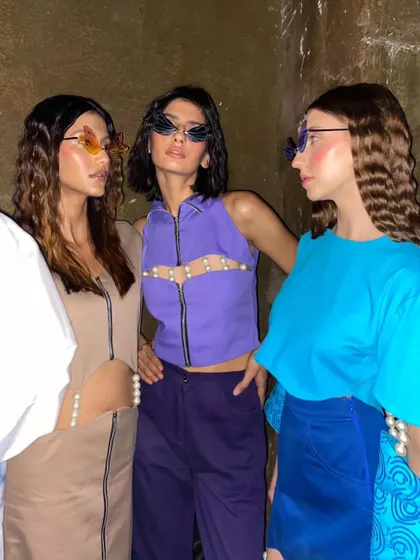 A backstage moment at the FAD show. This editorial look features heavy blush draping and glossy skin, creating a trendy and high-fashion vibe.
