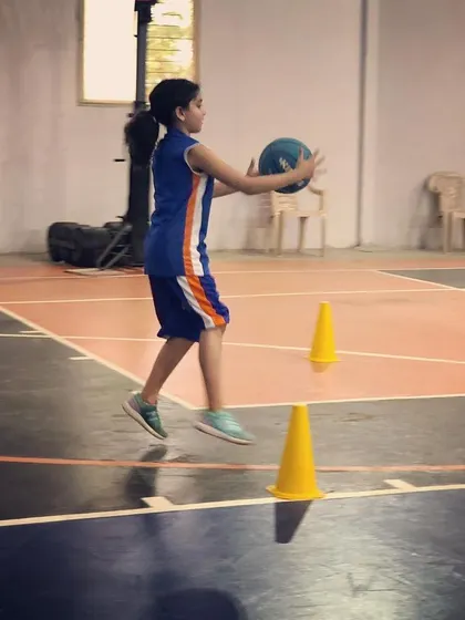 A young athlete focuses on securing the ball during a drill. We teach players to be strong and decisive with every movement.