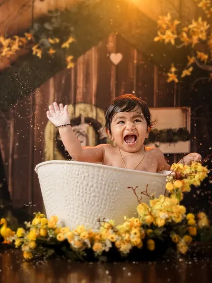 A moment of pure, unscripted joy as this little one splashes and shouts with excitement during the bath time shoot.