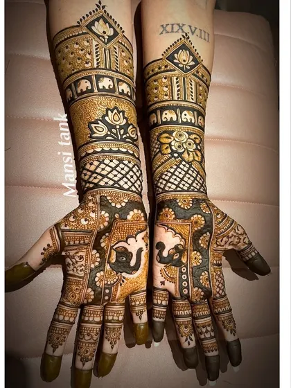 This engagement mehendi is packed with detail, featuring traditional elephant and lotus motifs. To make it extra special, I incorporated the couple's special date in Roman numerals on the forearm.