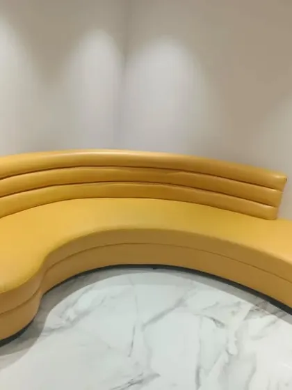 This custom-designed curved sofa is an example of a finished furniture piece from one of my projects. Selecting or creating unique furniture is a final touch that brings personality and function to a space.