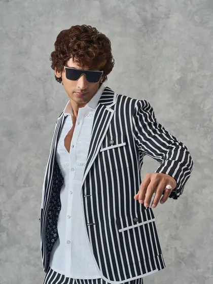 A confident pose in my black and white striped suit. This look is designed for the modern man who appreciates a blend of classic patterns and contemporary tailoring.