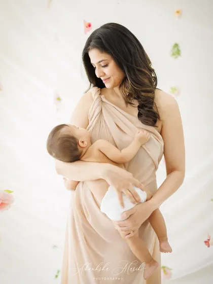 A serene and artistic portrait of a mother and her newborn. The image is soft, gentle, and full of the quiet love of the first few weeks.