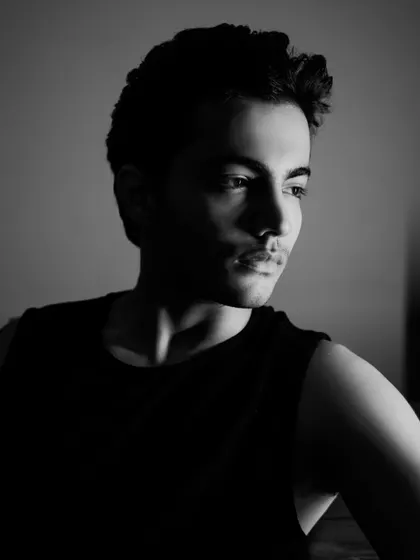 A classic three-quarter portrait in black and white, with soft lighting that highlights the actor's features.