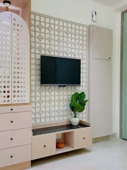 A modern TV unit that also incorporates a stylish pooja unit with a perforated door. This is a great example of our multi-functional and space-saving designs.
