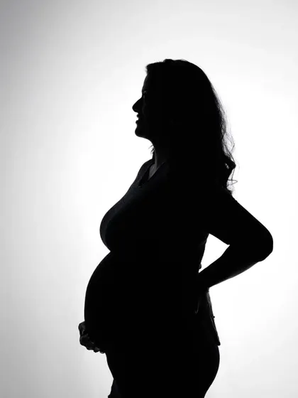 A classic maternity silhouette portrait. Using backlighting in the studio, I capture the beautiful profile of the mother-to-be, creating a timeless and artistic black and white image.