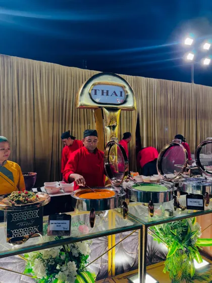 My live Thai food station, featuring chefs serving red and green curries from elegant chafing dishes.