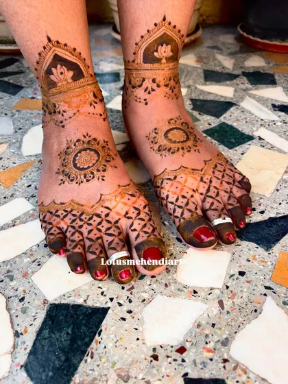 The feet mehendi for the baby shower, with a design that complements the intricate patterns on the hands.