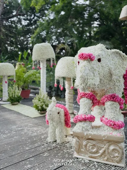 An adorable elephant statue made entirely of white and pink flowers. We love creating custom floral sculptures that add a whimsical and personalized touch to the decor.