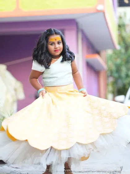 The other twin, looking just as cute in her custom designed lehenga.