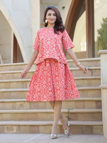 Another look at the coral pink geometric print set, styled for an elegant occasion.
