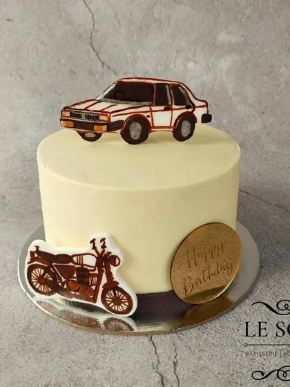 This cake was a special request to feature classic vehicles. I used dark brown buttercream instead of black to create the hand-piped car and motorcycle for a vintage feel.