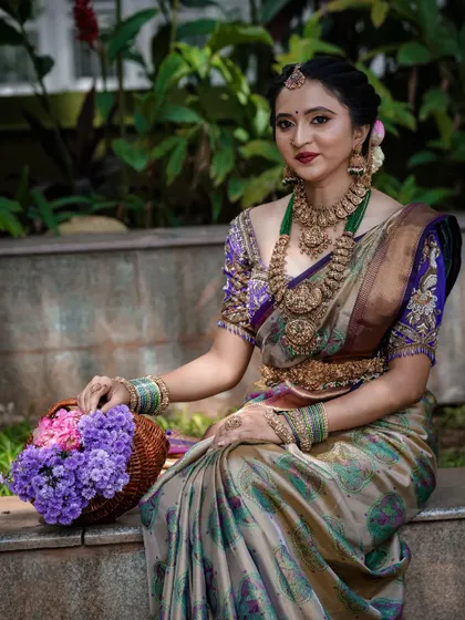 A closer look at the bridal ensemble, showing the intricate details of the temple jewelry against our traditional silk saree. The combination of the soft silk and the grand jewelry is perfect for wedding photos.