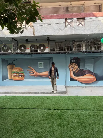 Another perspective of the full 3D mural at the cafe, showing how it occupies the length of the wall and creates a dynamic visual experience from different angles.
