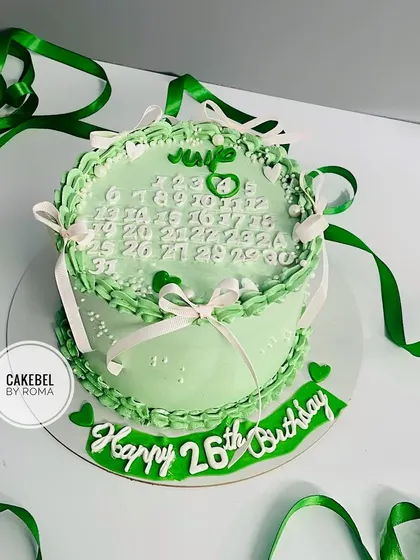 A lovely green vintage-style cake for a 26th birthday, featuring a calendar marking the special day.