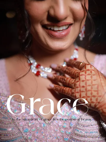 Grace. This close-up shot focuses on the bride's radiant smile and the intricate details of her necklace and henna, capturing the essence of her beauty.