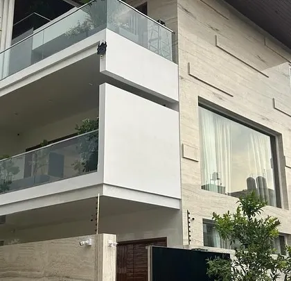 The exterior of a modern villa where I handled the landscaping. The balconies are designed to hold plants, seamlessly blending the indoor and outdoor green spaces.