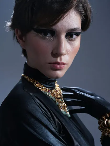 For this fashion editorial, the goal was a powerful and chic look. I created a bold, black graphic winged liner with a touch of gold glitter underneath to catch the light.