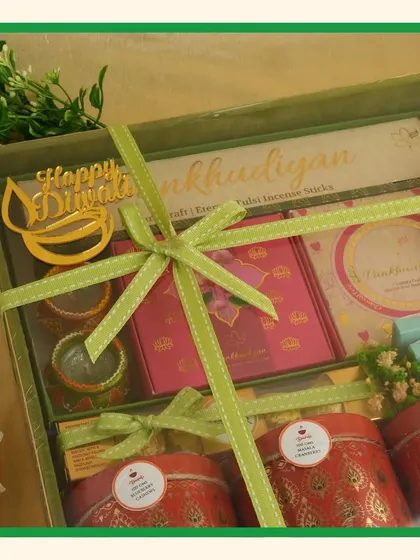 This green-themed hamper is perfect for celebrating prosperity. It includes a "Happy Diwali" diya cutout and is tied with a lime-green ribbon for a fresh, festive look.