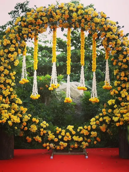A full view of the circular marigold arch, a popular choice for vibrant Haldi ceremony backdrops in Bangalore.