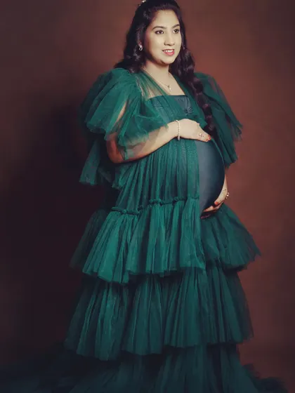 The emerald green gown is one of my fastest-moving pieces. Its rich color and dramatic design make it a favorite for maternity shoots.