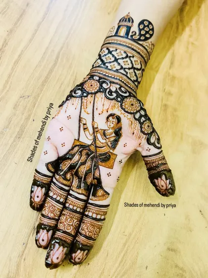 A special design for the Teej festival, featuring a woman on a 'jhula' (swing). This is a classic scene that I love to create, surrounded by intricate patterns that extend up the wrist.