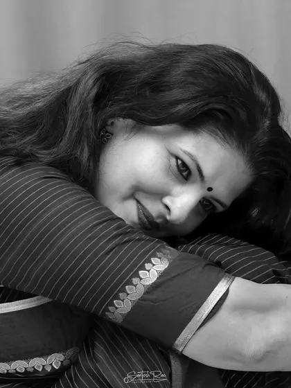 A monochrome portrait in a striped saree, focusing on the emotion and texture. Black and white photography brings a different kind of drama to ethnic wear.