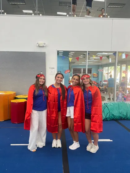 A team of superheroes in red capes, ready for action. Our staff is divided into color-coded teams to add to the fun of our themed events and parties.