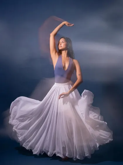 A beautiful motion-blur image that captures the swirl of the skirt and the elegance of the pose.