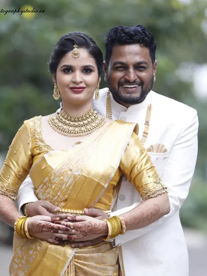 A beautiful portrait of a couple on their engagement day, dressed in stunning golden attire. We capture the elegance and excitement of this special occasion.