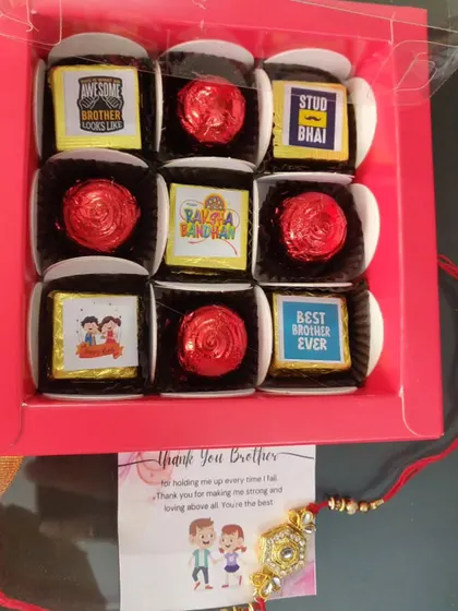 A box of 9 Rakhi chocolates, mixing personalized message chocolates with foil-wrapped ones, plus a rakhi and card.
