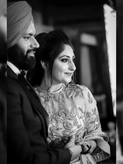 The black and white version of a candid engagement moment. This edit emphasizes the couple's expressions and the intimate connection they share.