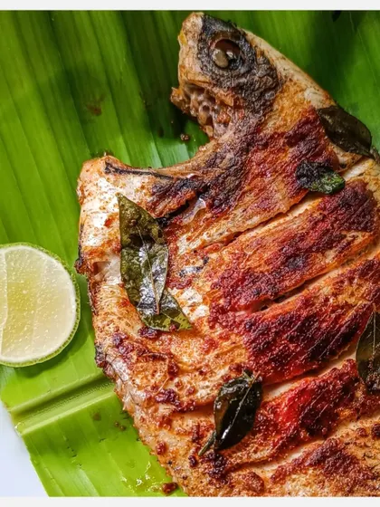 The head of the grilled Karimeen, a delicacy for many fish lovers, served with a fresh slice of lime.