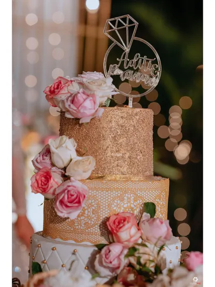 A close-up of the beautiful three-tiered engagement cake, a centerpiece of the celebration.