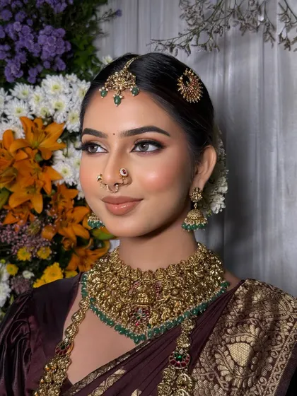A classic bridal portrait. The saree is draped to perfection, creating a look that is both traditional and timeless.