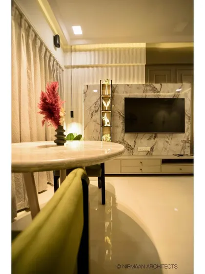 A view across the dining table to the TV unit in this modern classic home. The layout ensures that the dining and living areas feel connected, yet have their own distinct zones.