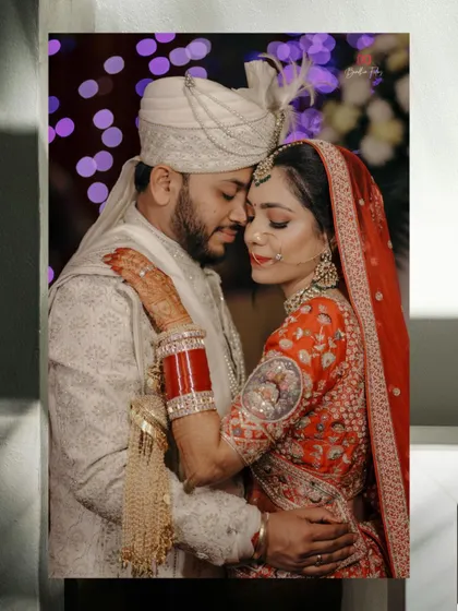 An intimate and romantic wedding portrait, with the couple in a close embrace, framed to feel like a private, stolen moment.