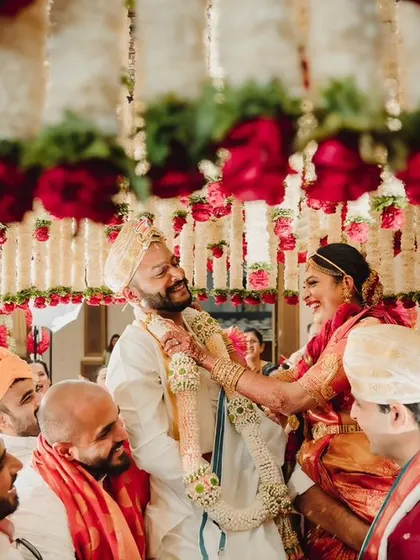 A fun and playful moment during the 'varmala' or garland exchange ceremony, captured perfectly.