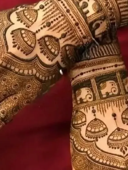 A playful and traditional design featuring jhumka (earring) and elephant motifs. The patterns are dense and intricate, perfect for a bride who loves classic symbols.