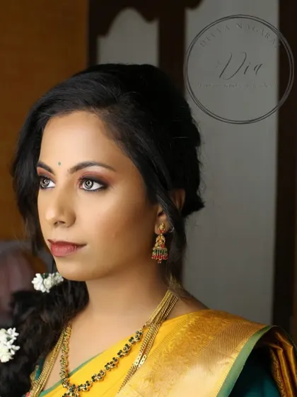 A side profile of the Haldi look, showing the soft smokey eye and the traditional braided hairstyle adorned with flowers. Even for pre-wedding events, I ensure the makeup is polished and picture-perfect.