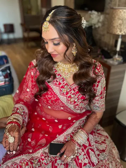A candid moment during the getting ready process. Her soft glam makeup with a focus on luminous skin is perfect for her wedding day.
