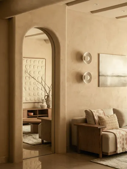 This view through an arched mirror demonstrates spatial storytelling. The reflection creates a choreographed journey for the eye, revealing the living space beyond and adding depth and light.