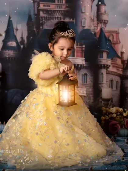 A real-life princess in her castle. This beautiful shot features a stunning yellow gown and a magical, fairy-tale backdrop.