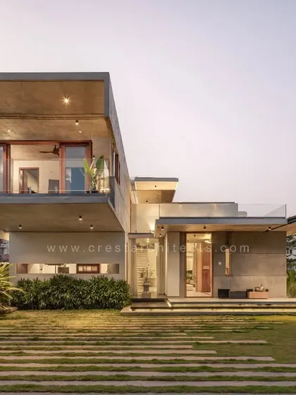 The Quarry House at dusk, where landscape lighting accentuates the raw texture of the concrete and the clean lines of the 18-foot cantilever.