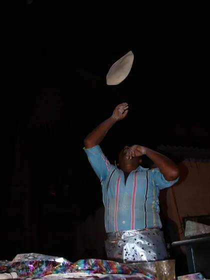 The skill of our chef is on display as he expertly tosses a Rumali Roti in the air, a sight that always entertains guests.