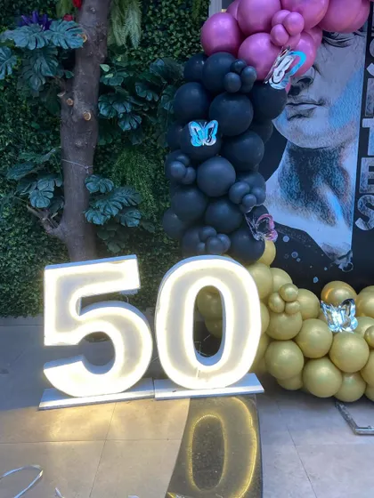 Large, illuminated marquee numbers are a fantastic way to highlight a milestone birthday, like this 50th celebration.